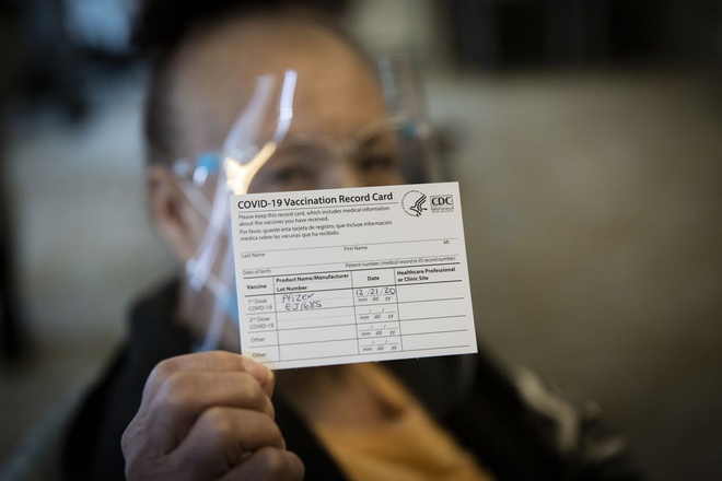 One_woman_holds_up_her_COVID_19_vaccination_card_after_receiving_the_vaccine_during_the_first_round_of_vaccinations_at_Oregon_US_nursing_homes_on_December_21_2020._The_Oregonian_.jpg (57 KB)
